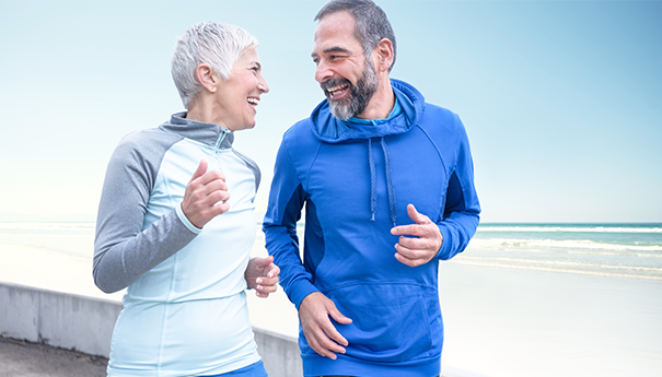 Couple running Older couple running outside in training gear